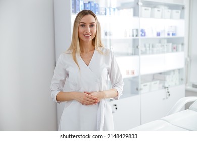 Cheerful young woman beautician standing in beauty salon - Shutterstock ID 2148429833