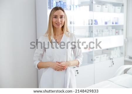 Cheerful young woman beautician standing in beauty salon ストックフォト © 