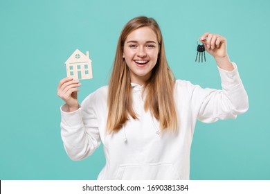 Cheerful Young Woman Girl In Casual White Hoodie Posing Isolated On Blue Turquoise Wall Background Studio Portrait. People Emotions Lifestyle Concept. Mock Up Copy Space. Hold House And Bunch Of Keys