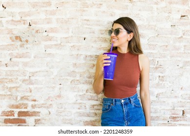 Cheerful Young Woman Having A Fun Time While Drinking A Cold Drink And Enjoying A Summer Hot Day Outside 