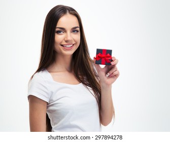 Cheerful Young Woman Holding Small Gift Box Isolated On A White Background And Looking At Camera