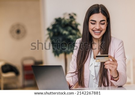 Cheerful young woman, looking at her bank insurance online.