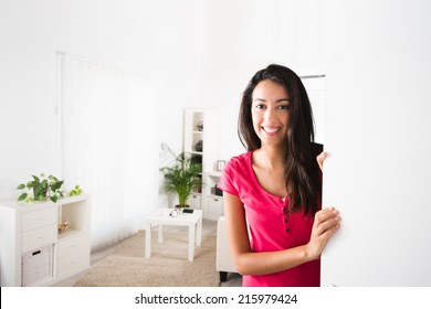 Cheerful Young Woman Opening Her House Front Door And Inviting Friends At Home 