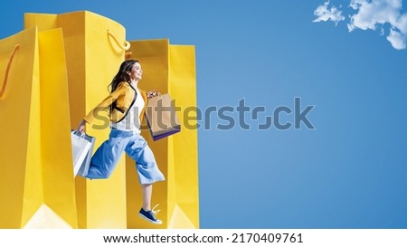 Cheerful young woman running and holding shopping bags, sales and fashion concept, blank copy space