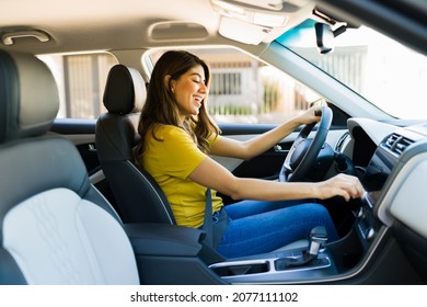 Cheerful Young Woman Singing In The Car While Driving And Listening To Music On The Radio 