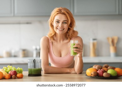 A cheerful young woman smiles while holding a green smoothie in a glass. Fresh fruits are arranged around her in a stylish kitchen, highlighting a healthy lifestyle and enjoyment of nutrition. - Powered by Shutterstock