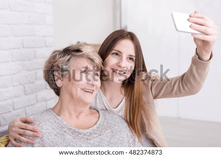 Similar – Caregiver looking through the window with elderly patient in wheelchair