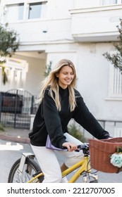 Cheerful Young Woman In Trendy Outfit Riding Bicycle On Street In Turkey