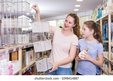 Cheerful Young Woman With Tween Girl Shopping For Bathroom Accessories In Home Decor Shop