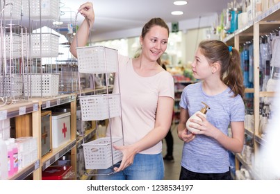 Cheerful Young Woman With Tween Girl Shopping For Bathroom Accessories In Home Decor Shop