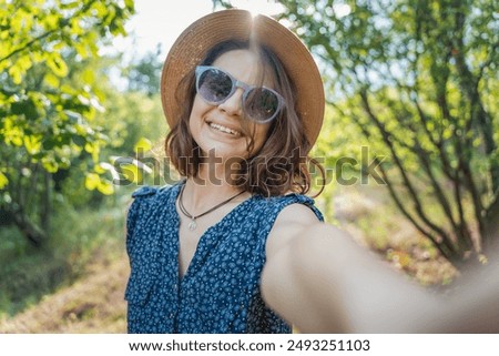 Similar – Happy young woman looking back through the window car