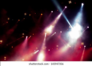 Cheering Crowd In Front Of Bright Stage Lights