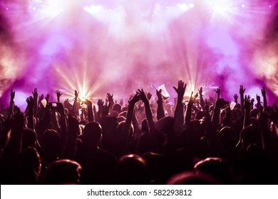 cheering crowd at a rock concert - Shutterstock ID 582293812