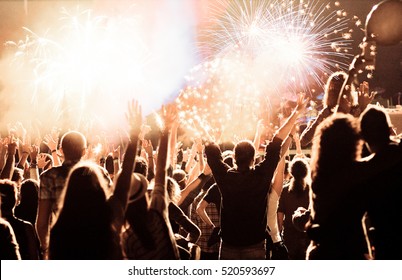 Cheering Crowd Watching Fireworks At New Year - Holiday Celebration Background