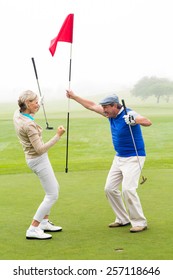 Cheering Golfing Couple On A Foggy Day At The Golf Course