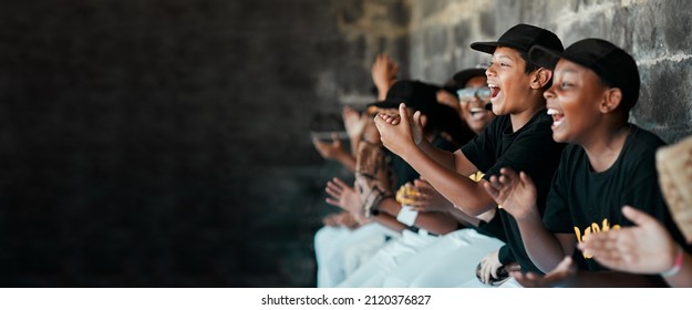 Cheering On Their Team. Cropped Shot Of A Group Of Young Baseball Players Cheering And Supporting Their Team From The Bench During A Game.