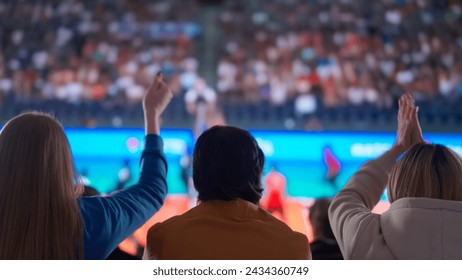 Cheering Volleyball Fans Celebrating at a Sports Arena - Powered by Shutterstock