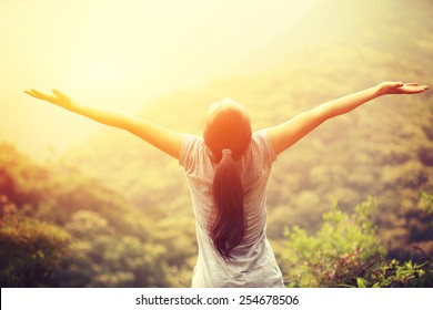 Cheering Woman Enjoy The Beautiful View At Mountain Peak 