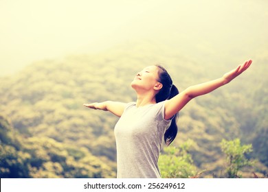 Cheering Woman Enjoy The Beautiful View At Mountain Peak 