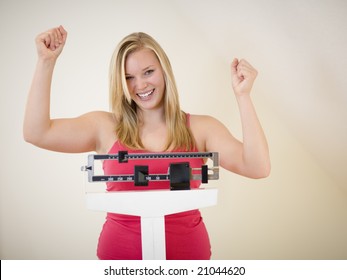 Cheering Woman Standing On Scale