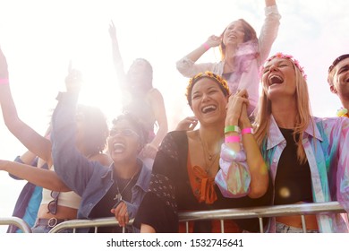 Cheering Young Friends In Audience Behind Barrier At Outdoor Festival Enjoying Music - Powered by Shutterstock