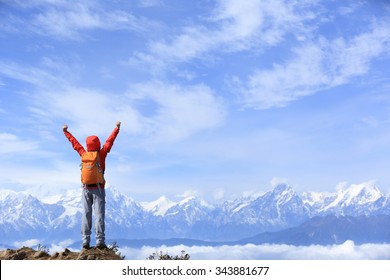 Cheering Young Woman Hiker Open Arms At Mountain Peak To The  Frozen Mountain Summits