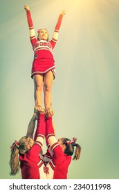 Cheerleaders In Action On A Vintage Filtered Look - Concept Of Unity And Team Sport - Training At College High School With Young Female Teenagers - Vintage Filtered Look