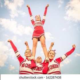 Cheerleaders Team With Male Coach