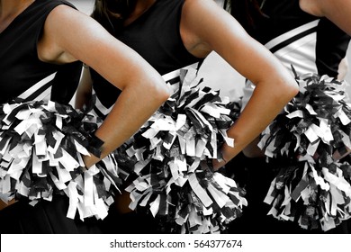 Cheerleaders in Uniform Holding Pom-Poms