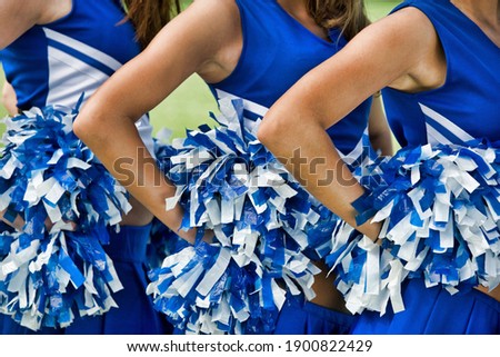 Cheerleaders in Uniform Holding Pom-Poms Zdjęcia stock © 