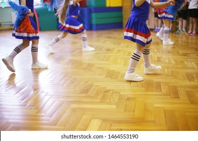 Cheerleading Class In School In A Sport Hall. Girls In Sneakers And Skirts. Back To School Activities. Children Education And Development. Dancing And Fun.