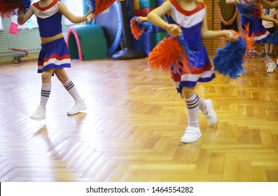 Cheerleading Class In School In A Sport Hall. Back To School Activities. Children Education And Development. Dancing And Jumping During Training.