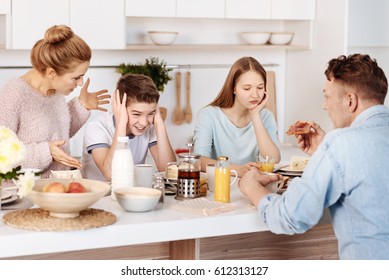 Cheerless family having breakfast in the kitchen - Powered by Shutterstock