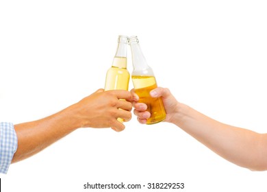 Cheers! Closeup Of Hands Toasting With Bottles Of Beer. Isolated On White.