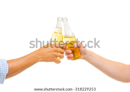 Cheers! Closeup of hands toasting with bottles of beer. Isolated on white.