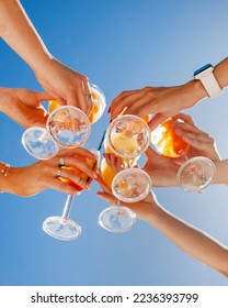 cheers with glasses. summer cocktails with friends on the background of the sky - Shutterstock ID 2236393799