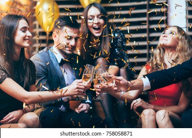 Cheers! Group Of Friends Clinking Glasses Of Champagne During Party Celebration. New Year, Birthday, Holiday Event Concept