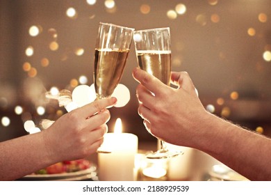 Cheers, toast and celebration with a couple on a romantic date for their engagement, anniversary or honeymoon. A candle lit dinner with wine glasses in the hands of a man and woman in a restaurant