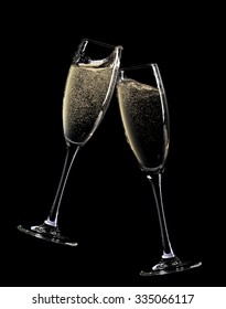 Cheers! Two Champagne Glasses. Isolated On Black Background