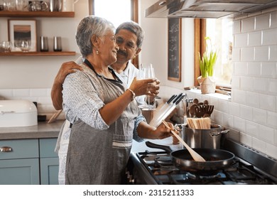 Cheers, wine and old couple at in kitchen cooking food together at stove with smile, love and romance. Toast, drinks and senior woman with man, glass and happiness to make dinner meal in retirement