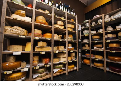 Cheese Arranged In Shelves At Store