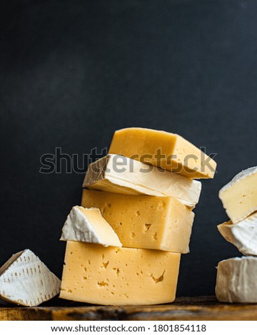 Assortment of cheeses and wine on wooden table