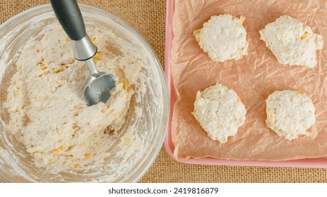 Cheese biscuits recipe, baking process. Scooping biscuit daugh into a baking pan