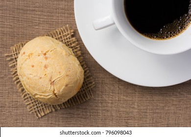 Cheese Bread Known As Pao De Queijo In Brazil (from Minas Gerais); Chipa In Paraguay; Pandebono In Colombia, Pan De Yuca In Ecuador And Cunape In Bolivia. Snack And Cup Of Coffee On Wood, Overhead.