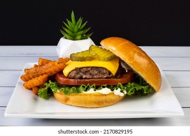 Cheese Burger On A Brioche Bun  And  Served With Sweet Potato Fries