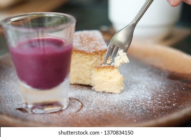 cheese cake with berry sauce syrup in glass on wood tray - Shutterstock ID 1370834150