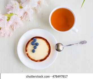 Cheese Cake With Blueberry And Cup Of Tea On White Background, Top View