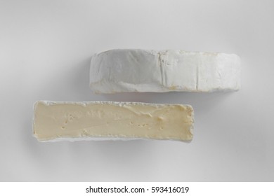 Cheese Camembert Or Brie On White Background. Menu Design Restaurant. Top View Design Photo. Cheese In White Paper. Overhead. Flat View Horizontal Photo. 