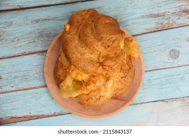 Cheese chouquette on a wooden plate