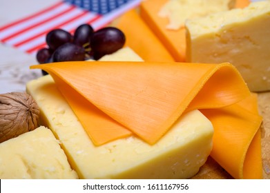 Cheese Collection, Blocks And Slices Of Yellow And Matured American Cheddar Cheese With Flag Of USA, American Food Concept